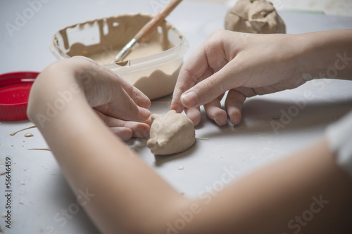 Girl make toyfrom clay