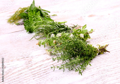Herbs in bundle on white wooden background