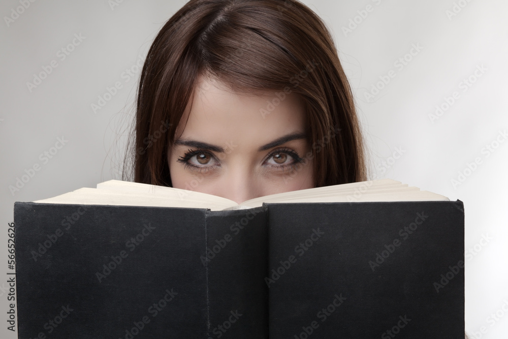 peering over book peering over book