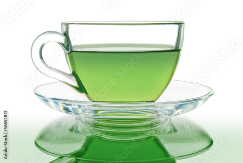 Green tea in a glass bowl on a white background.