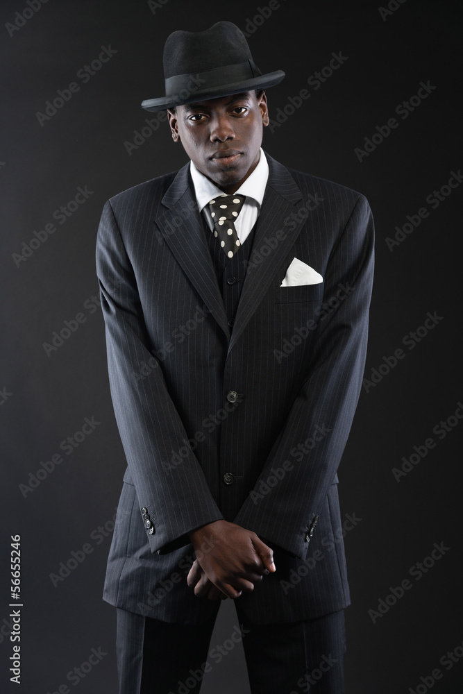 Retro african american gangster wearing striped suit and tie and