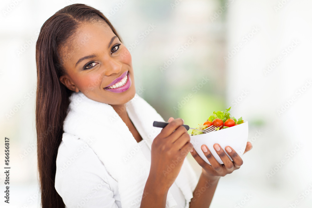 african woman holding bowl of green salad african woman holding bowl of green salad