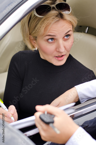 Woman looking startled as she signs a contract