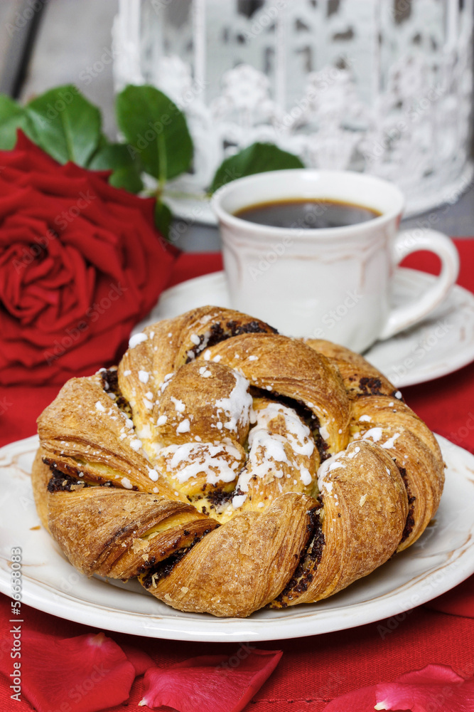 Festive braided bread on white plate. Rose petals around, bouque Festive braided bread on white plate. Rose petals around, bouque