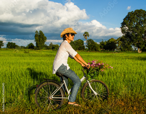Fototapeta Naklejka Na Ścianę i Meble -  Farmer riding bicycle