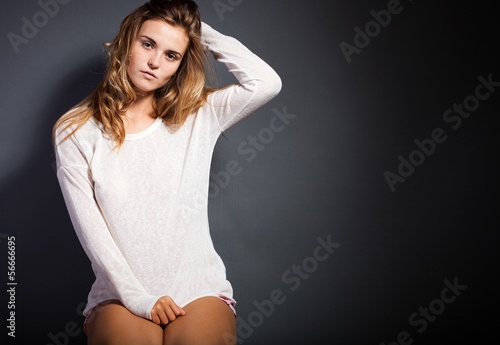 Slika na platnu Sexy young woman wearing white long sleeve t-shirt, sensual