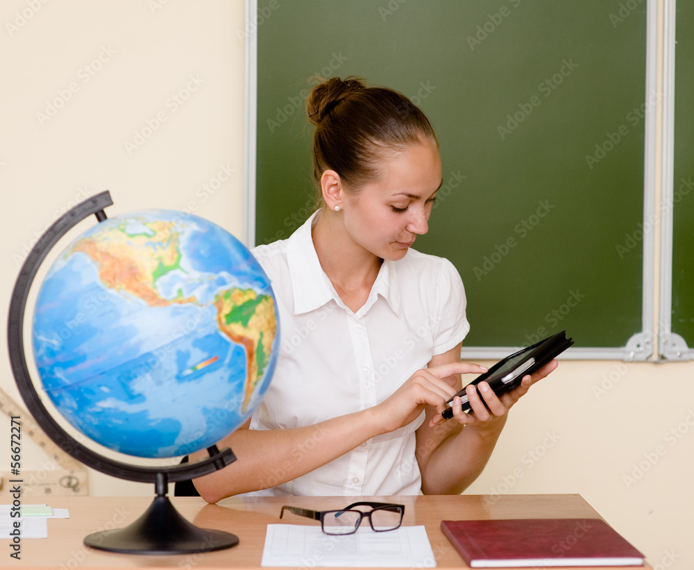 Teacher holding a tablet computer at classroom Teacher holding a tablet computer at classroom