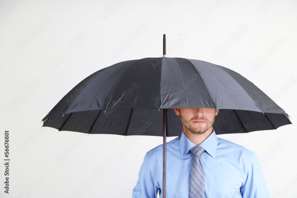 Businessman with umbrella. on gray background