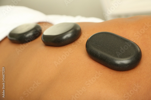 Hot stones on back before massage close up
