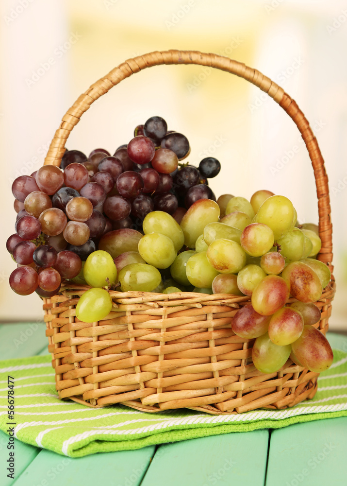 Fresh grape on wicker mat on bright background Fresh grape on wicker mat on bright background