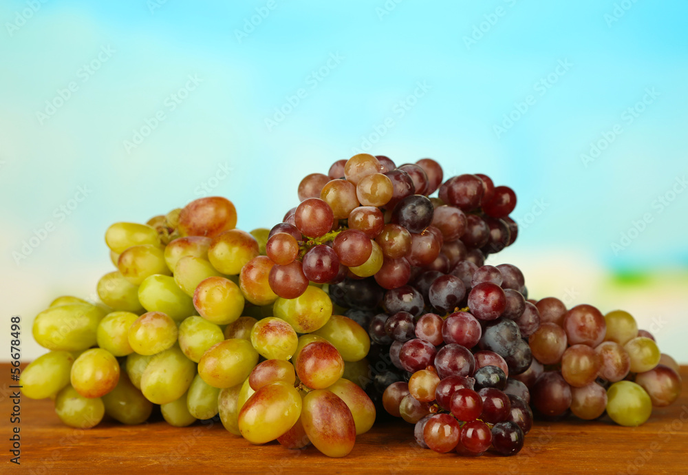Fresh grape,on wooden table, on bright background
