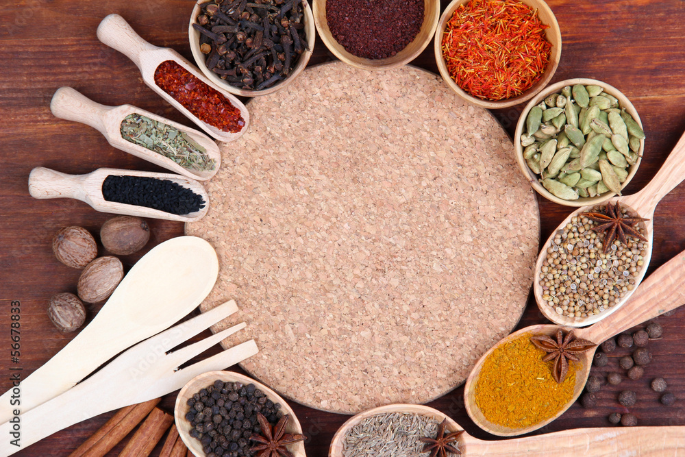 Various spices and herbs with empty board Various spices and herbs with empty board