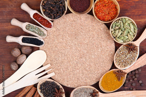 Various spices and herbs with empty board
