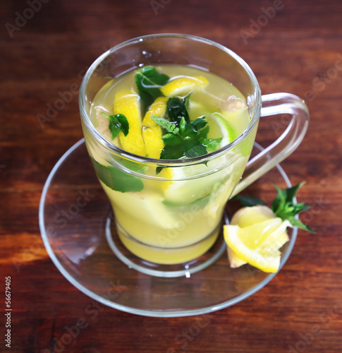 Cup of tea with ginger on wooden table