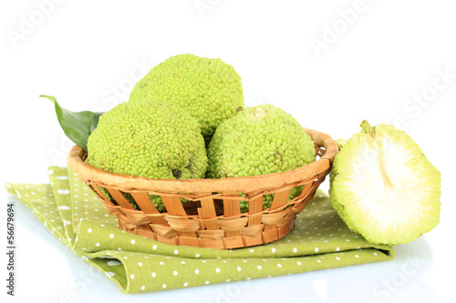 Osage Orange fruits (Maclura pomifera) in basket, isolated photo