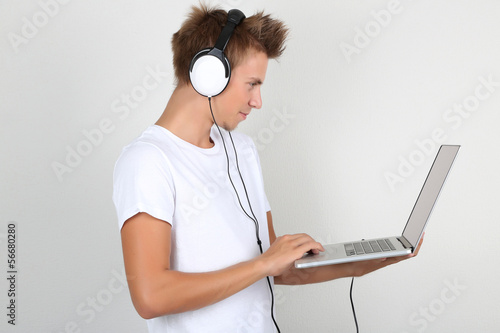 Handsome young man listenin...