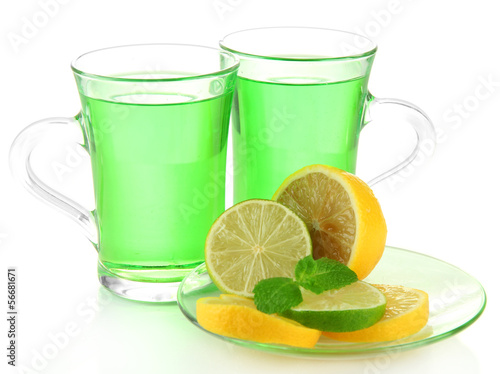 Two transparent cups of green tea with mint and lemon isolated