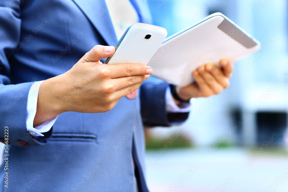 young businesswoman using digital tablet and mobile phone young businesswoman using digital tablet and mobile phone
