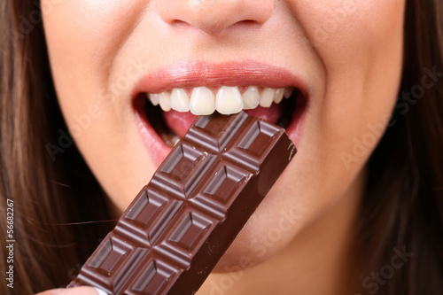 Closeup of woman eating chocolate