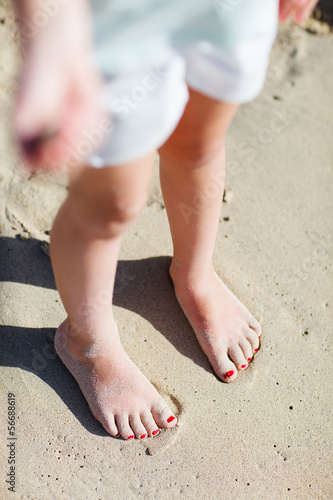 Feet on tropical sand