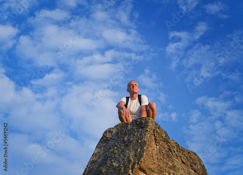 Man sitting on top of a rocky pinnacle