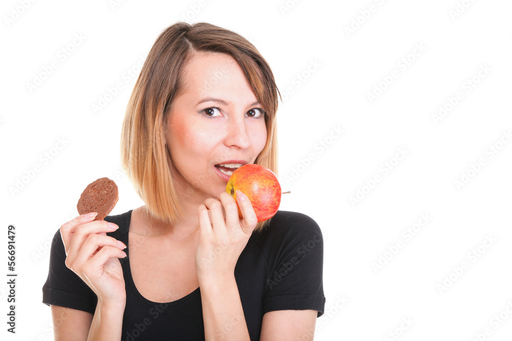 Young beautiful female choose from sweet cake and red apple Young beautiful female choose from sweet cake and red apple
