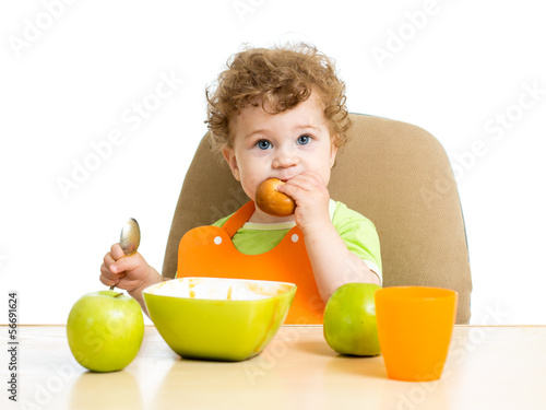 baby boy eating by himself