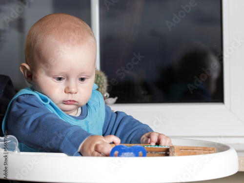 Baby boy sitting on the chair photo