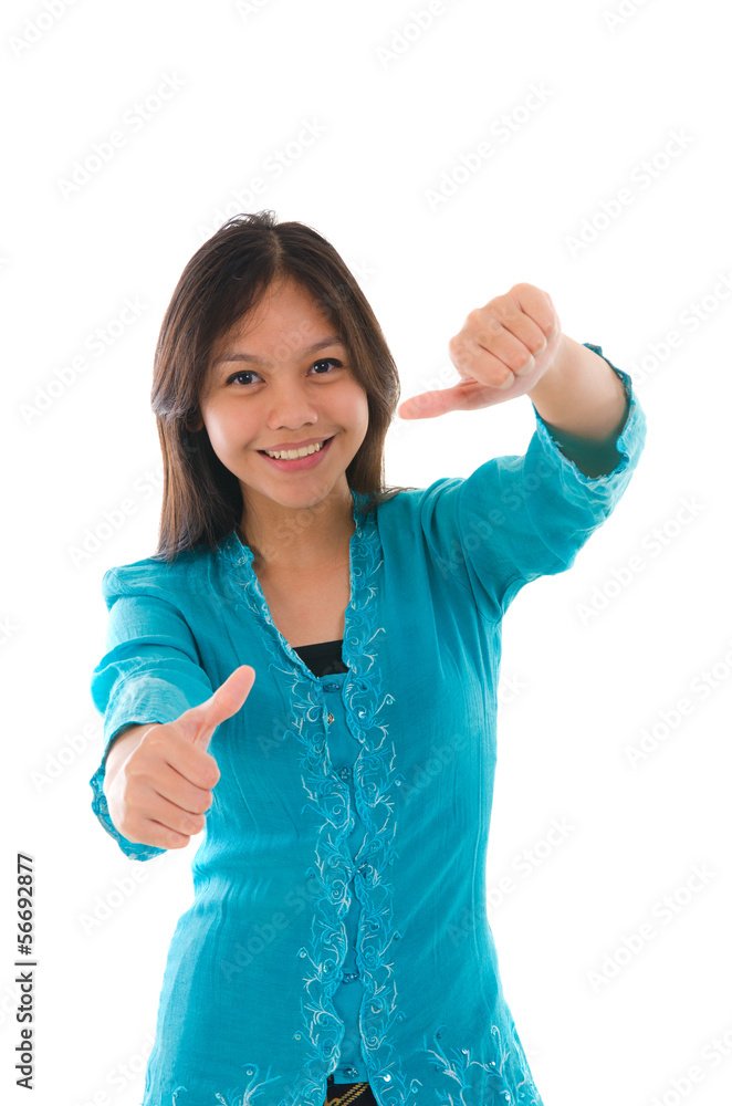Cute young Muslim girl giving a thumb up sign over white backgro Cute young Muslim girl giving a thumb up sign over white backgro
