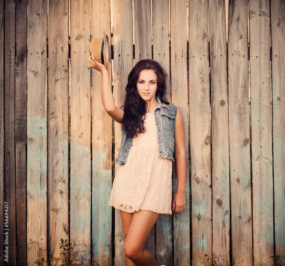 young beautiful girl on wooden wall young beautiful girl on wooden wall