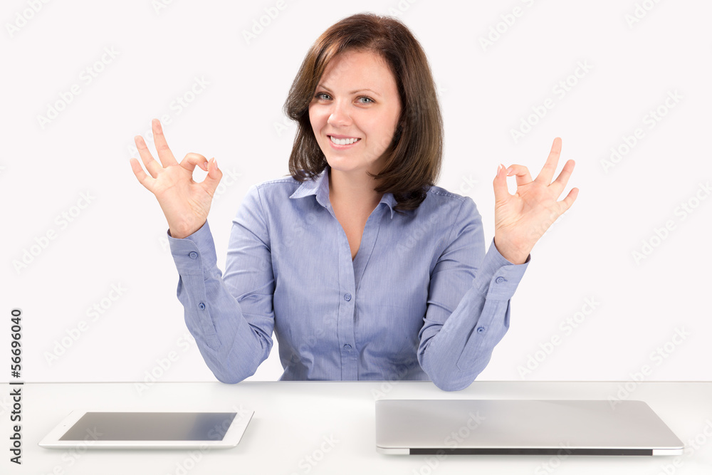 Business woman is sitting in front of a laptop and a tablet Business woman is sitting in front of a laptop and a tablet