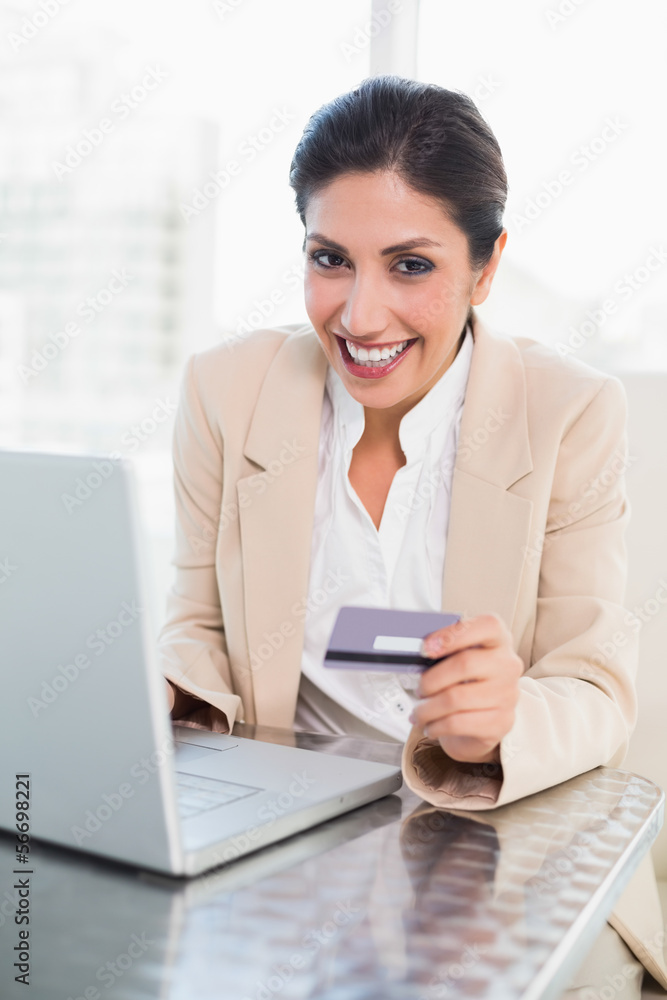 Happy businesswoman shopping online with laptop