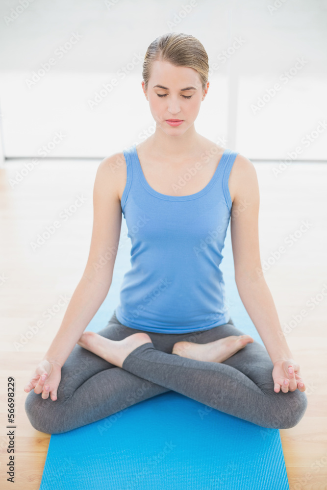 Peaceful pretty blonde relaxing in lotus position