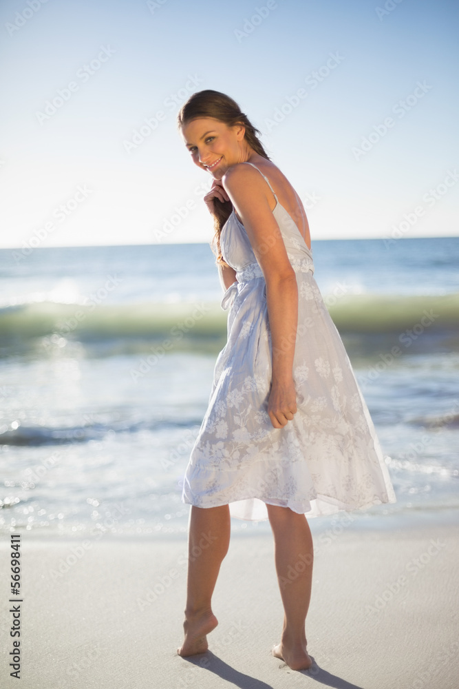 Smiling attractive woman looking over shoulder at camera Smiling attractive woman looking over shoulder at camera