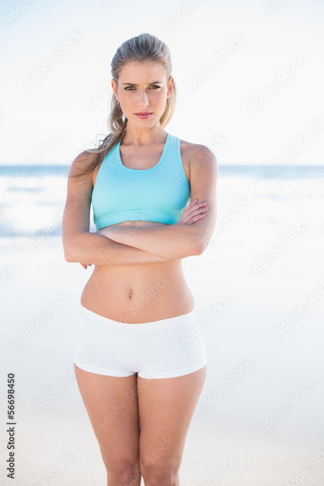 Serious sporty blonde in sportswear posing