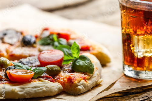 Baked pizza and served with cold drink