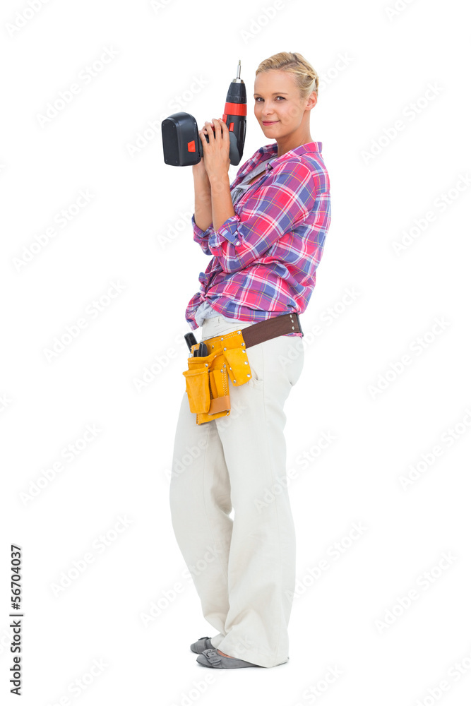 Smiling woman standing holding a drill Smiling woman standing holding a drill