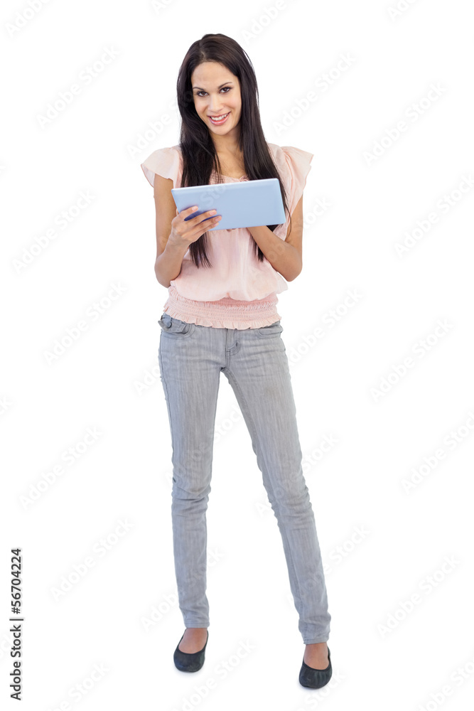 Smiling brunette using tablet pc Smiling brunette using tablet pc