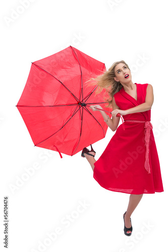 Beautiful woman wearing red dress holding umbrella © WavebreakmediaMicro