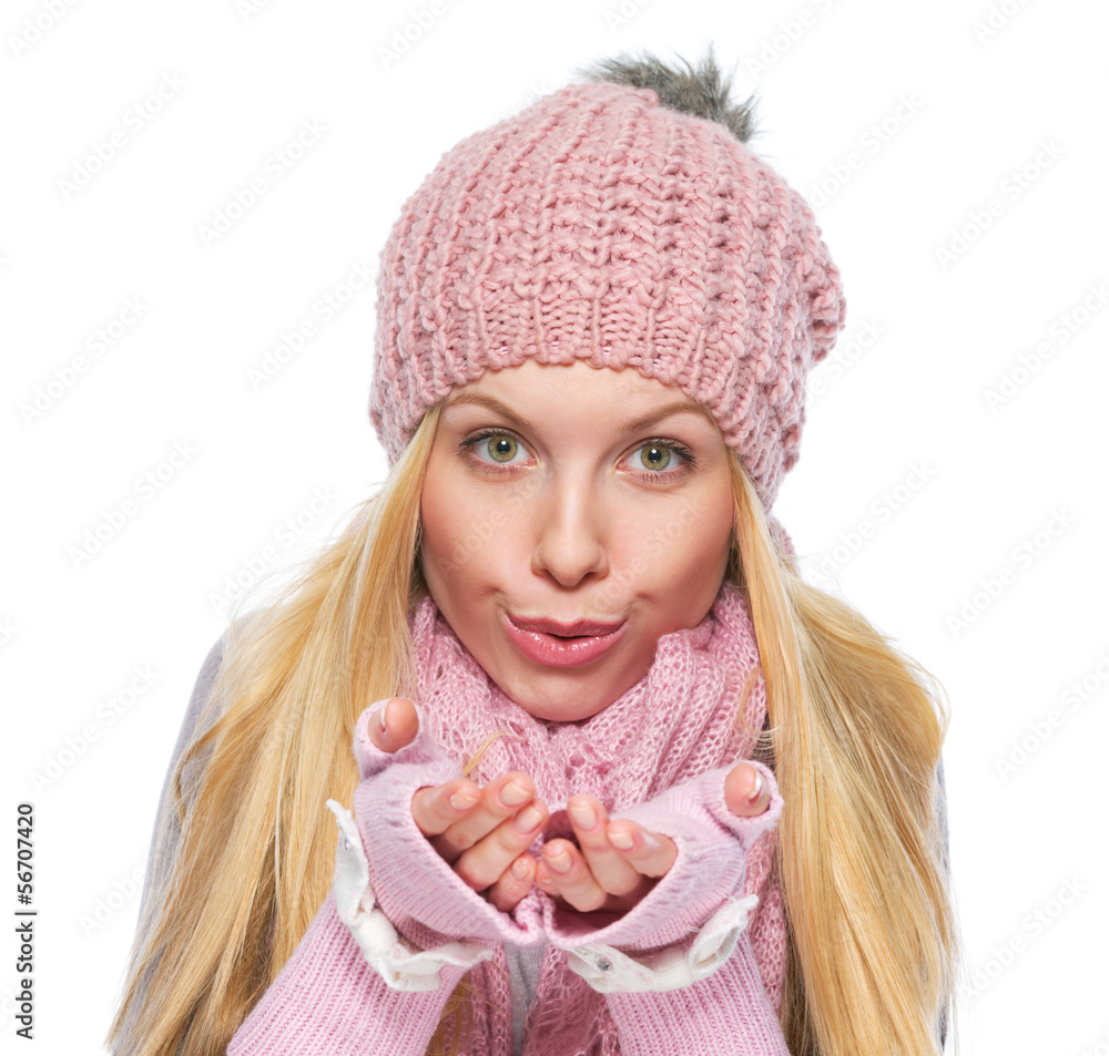 Girl in winter clothes blowing snow from hands Girl in winter clothes blowing snow from hands