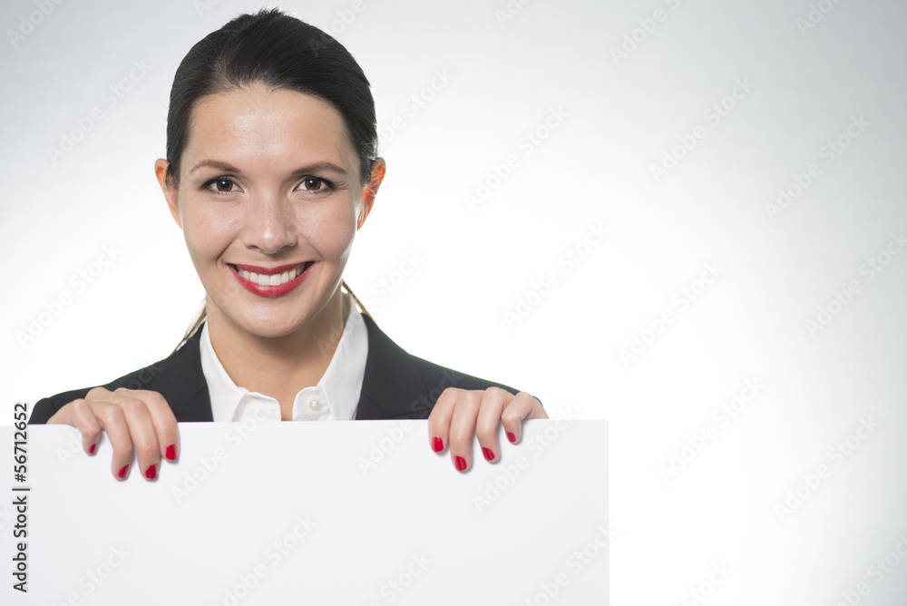 Smiling businesswoman holding a blank board Smiling businesswoman holding a blank board