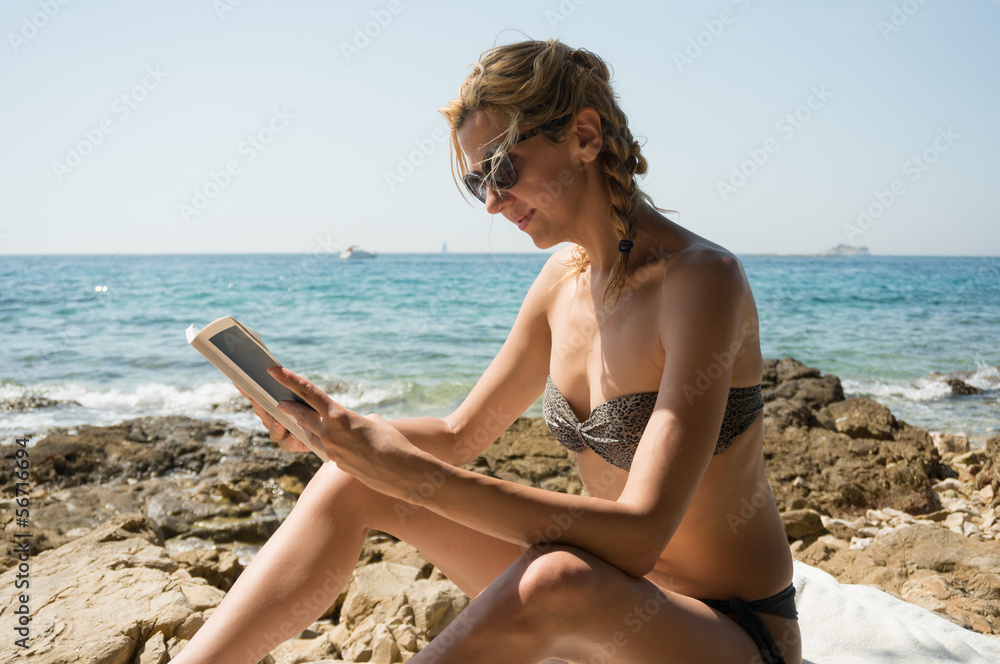 girl reading by the sea