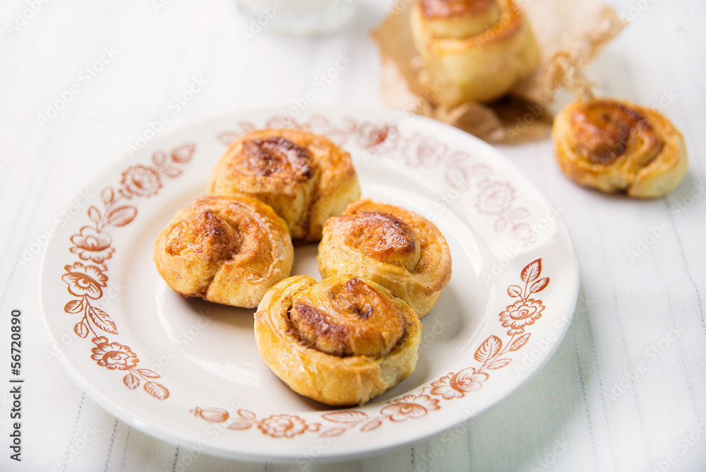 Brioches with cinnamon and glass of milk Brioches with cinnamon and glass of milk