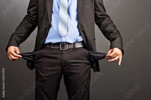 Business man showing his empty pockets photo