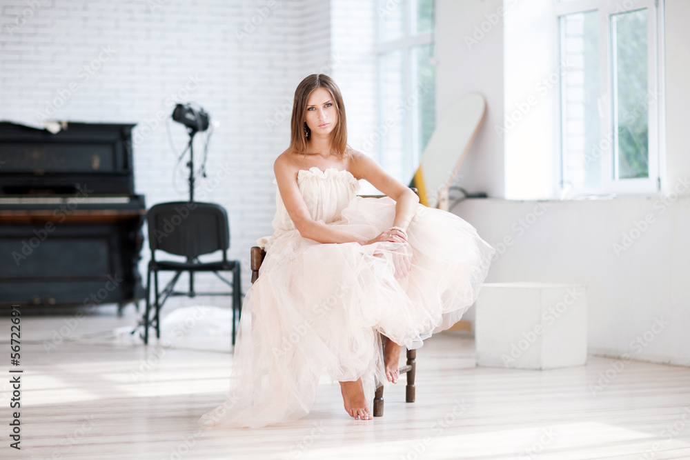 Bride sitting on chair on photo studio Bride sitting on chair on photo studio