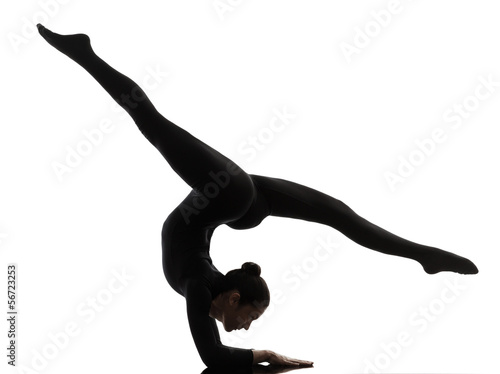 woman contortionist  exercising gymnastic yoga   silhouette photo