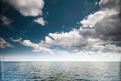 Cloudy blue sky above a surface of the sea