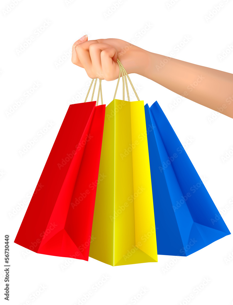 Female hand holding colorful shopping bags. Vector.