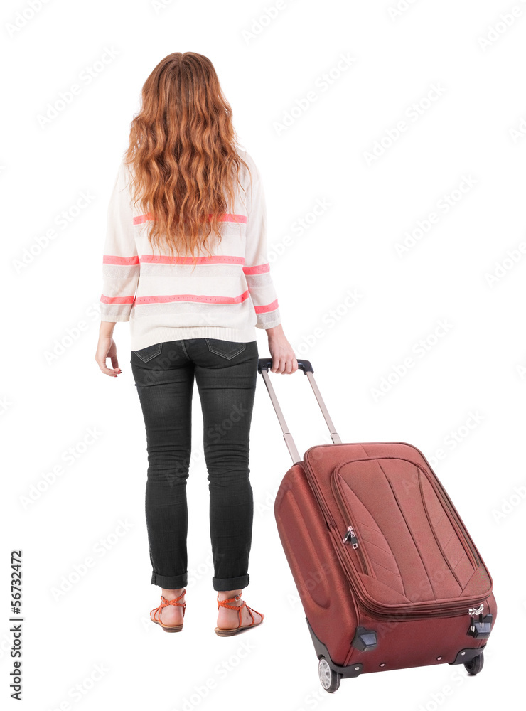 back view of walking woman with suitcase. back view of walking woman with suitcase.
