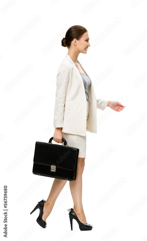 Profile of walking businesswoman with case Profile of walking businesswoman with case